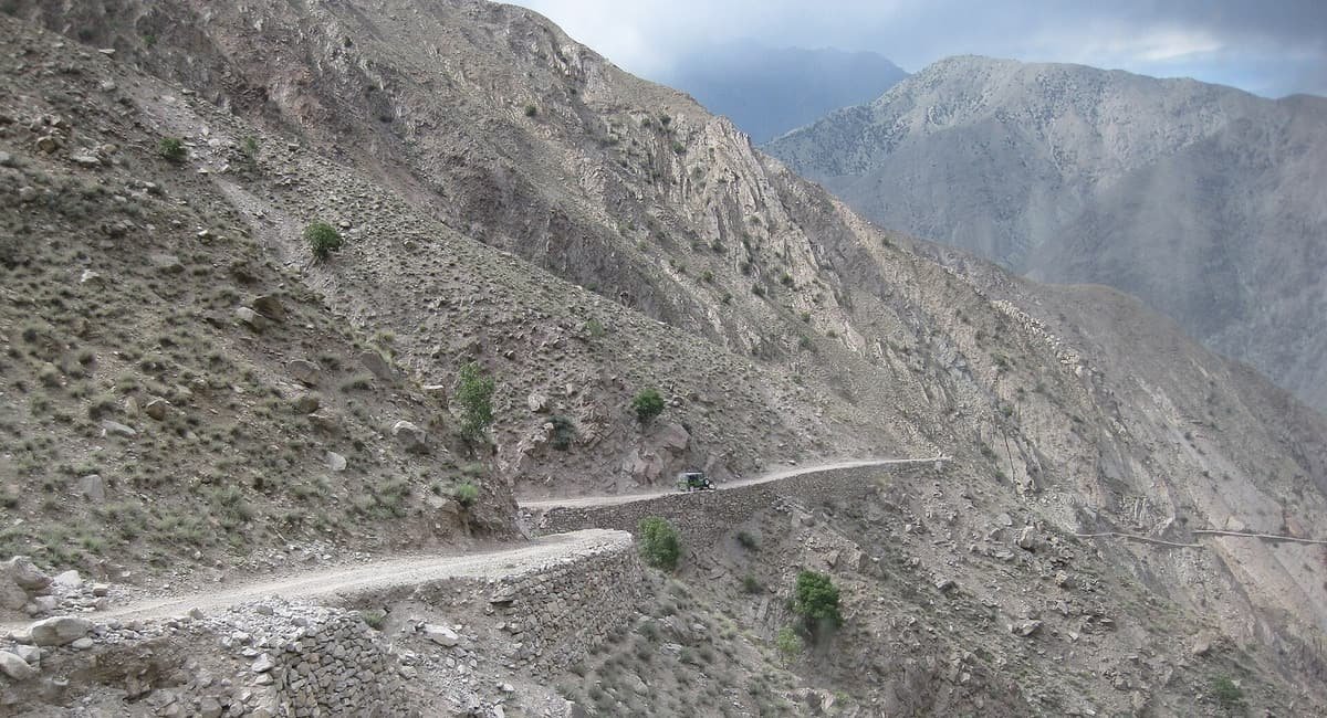 A narrow jeep track built on dry-stone walls clings to a barren mountainside on the route between Raikot and Fairy Meadows.